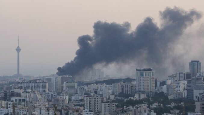 Smoke rises from a building belonging to the Iranian state broadcaster in Tehran after an Israeli strike